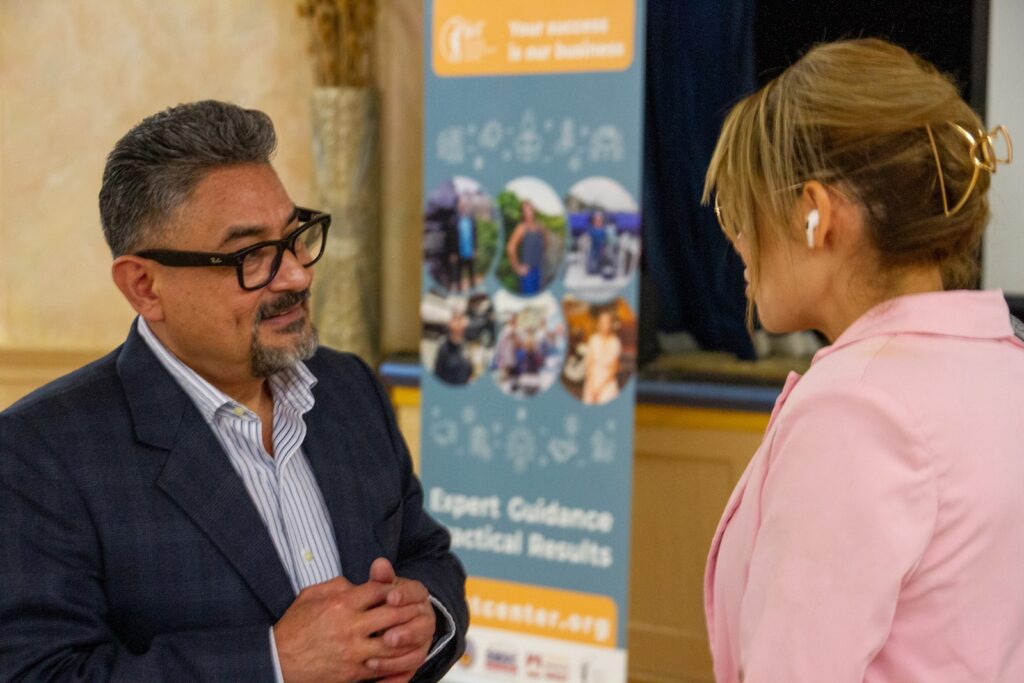 A West Center advisor meeting with a Spanish-speaking business owner